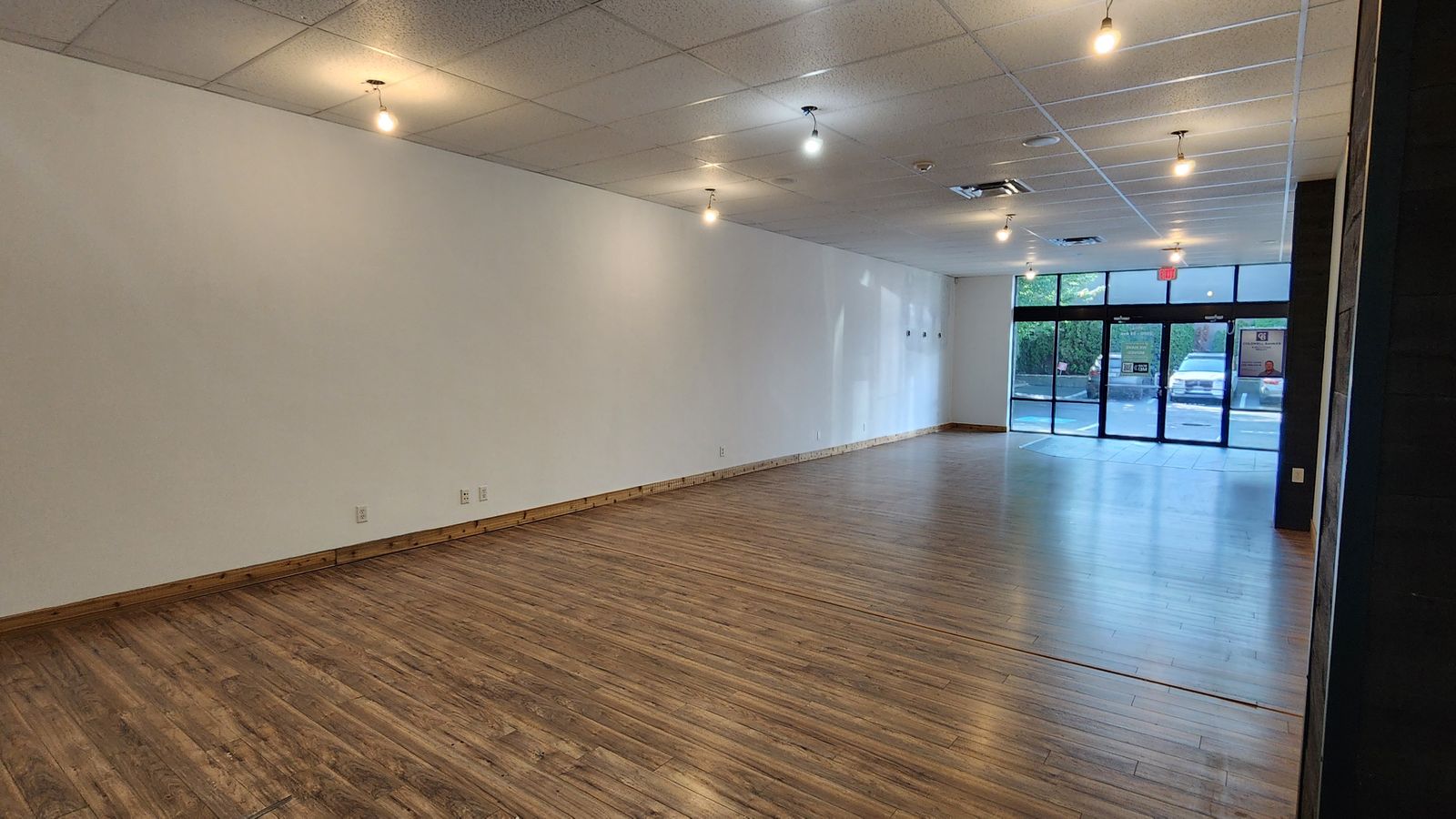 Open interior of Unit 102 looking toward the storefront windows