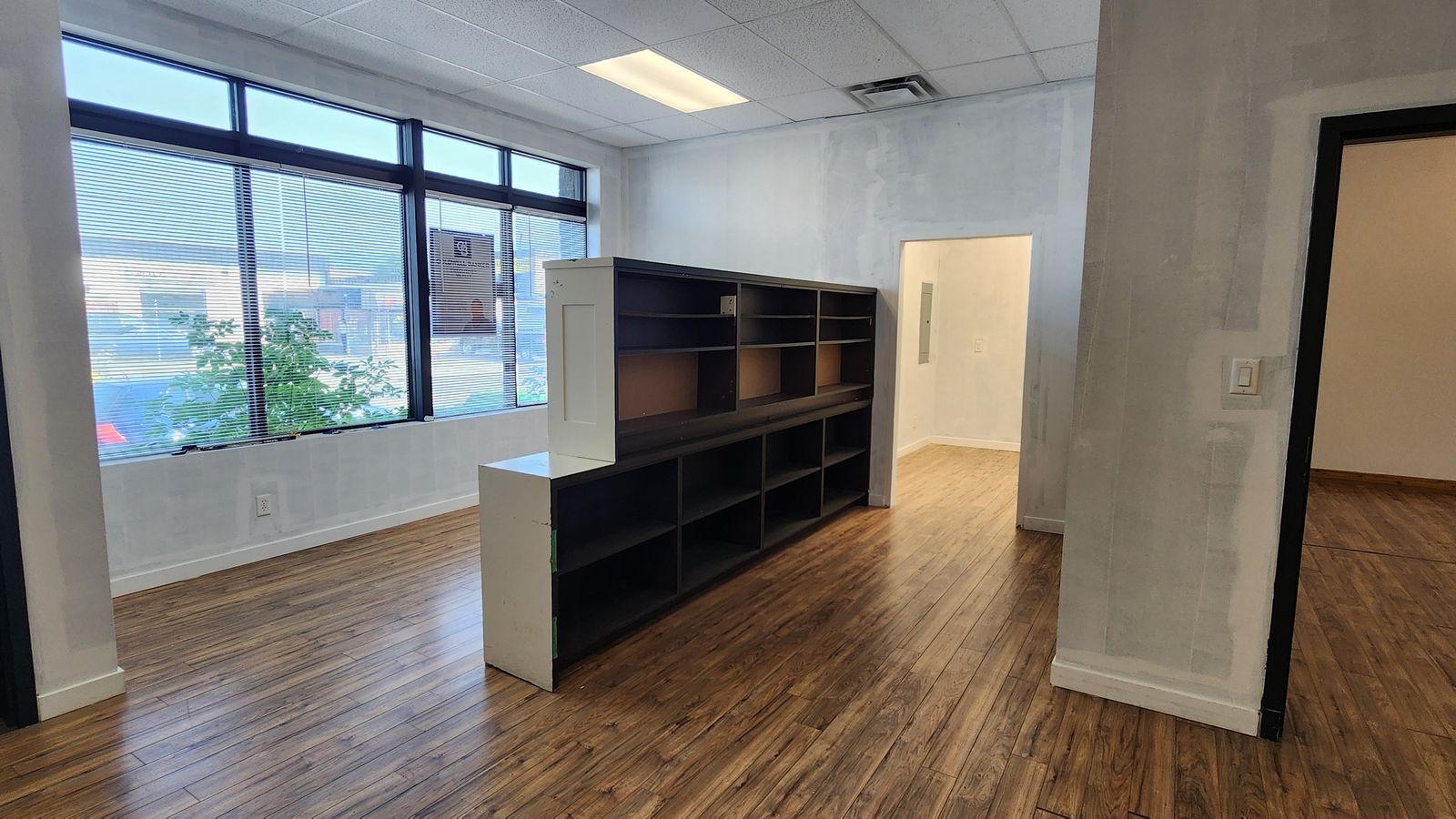Front office area with built-in shelving and large windows