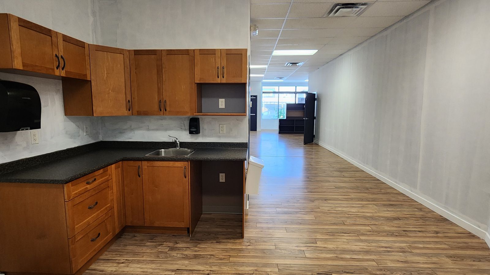 Kitchenette with cabinets and sink