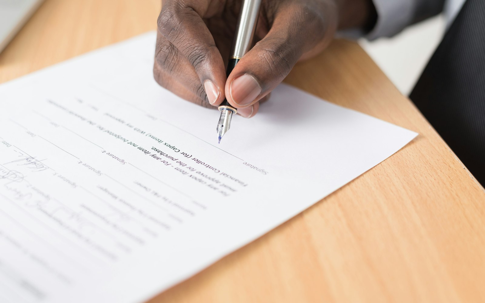 Signing contract pen desk